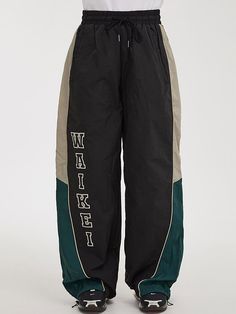 It is a relaxed fit racer pant in the brand’s unique color mood. The pant has logo embroidery for trendy design. The pant has piping along the seam and colorblock point that add casual vibe. The pant silhouette is adjustable using drawcords on the hem.- Unisex item- Elastic waist- Side pockets- Back pockets Green Streetwear Pants With Side Stripes, Green Sweatpants With Side Stripes For Streetwear, Green Pants With Side Stripes For Streetwear, Green Side Stripe Pants For Streetwear, Black Sporty Bottoms With Contrast Stitching, Green Bottoms With Side Stripes For Streetwear, Sporty Black Pants With Contrast Color, Sporty Streetwear Pants With Contrast Trim, Sporty Pants With Contrast Trim For Streetwear