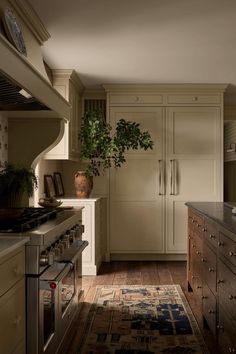 a kitchen with an oven, stove and cabinets in it's center island area