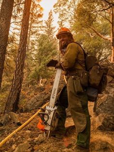 a man with a backpack and skis in the woods