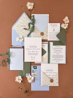 the wedding stationery is laid out on top of each other