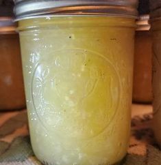 a jar filled with yellow liquid sitting on top of a table