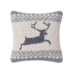 a knitted pillow with a reindeer design on the front and back, in grey and white