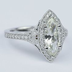 an oval cut diamond ring with pave set shoulders