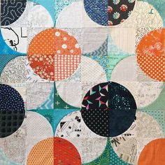 a patchwork quilt with multiple circles on it