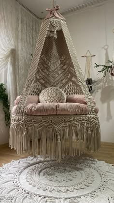 a hammock chair with pillows on top of it