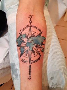 a person with a compass tattoo on their arm