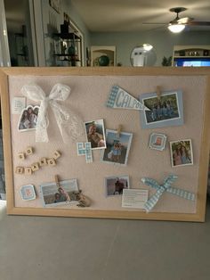 a wooden frame with pictures and clothes pins attached to it, sitting on a table