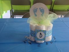 a blue table topped with lots of diapers and baby's feet on it