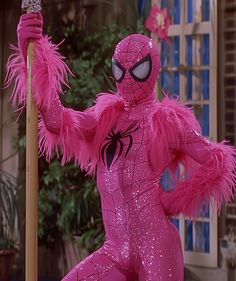 a person in pink costume holding a pole