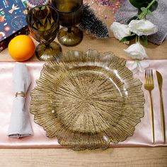 a place setting with flowers, candles and napkins