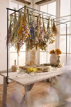 a table with dried flowers hanging from it's sides and the words instagram