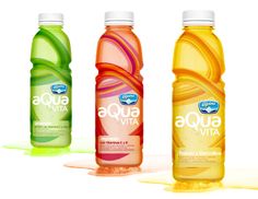 three bottles of aqua vita water on a white background, one is green and the other is orange