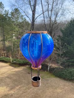 a blue glass lantern hanging from a chain