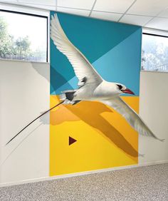 an office with a mural of birds painted on the wall