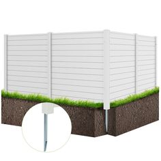 a white fence with grass growing out of it and the top section is cut open