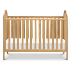 a wooden crib with white sheets on the bottom and sides, against a white background