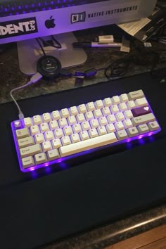 an apple computer keyboard sitting on top of a desk