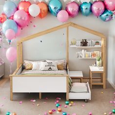 a bedroom decorated with balloons and confetti