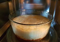 a glass dish filled with food sitting on top of a stove