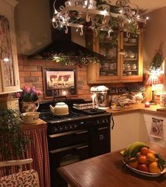 a bowl of fruit sits on the kitchen counter next to an oven with lights above it