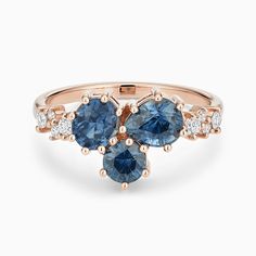 a rose gold ring with blue sapphires and diamonds