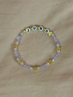 A hand-crafted glass bead friendship bracelet highlighting Sabrina Carpenter's song "Juno"! A simple and cute way to show off your favorite song or a great concert accessory!  This bracelet is made with Czech glass beads, plastic letter beads, plastic spacer beads, and is on an elastic thread measured at about 10 inches in length for a relaxed/loose fit. If you would like the bracelet you order to be smaller or larger, please leave the requested size in inches in the personalization box!  All bracelets are made to order and are typically shipped out within 1-3 business days unless otherwise stated. Sabrina Carpenter Bracelets, Bracelets Letter Beads, Concert Bracelets, Sabrina Carpenter Songs, Bead Friendship Bracelet, Beaded Friendship Bracelets, Plastic Letters, Friendship Bracelets With Beads, Elastic Thread