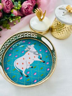 there is a plate with a horse on it and some flowers in the back ground