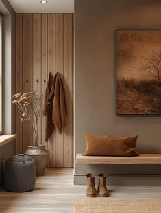 a wooden bench sitting in front of a window next to a painting on the wall