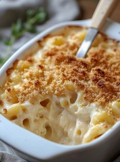 a white casserole dish with macaroni and cheese in it on a table