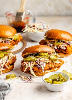 three chicken sandwiches with cole slaw and guacamole