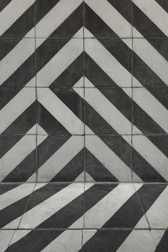 black and white tiles with diagonal stripes on them