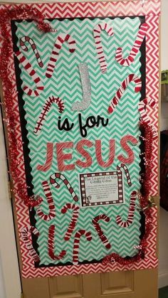 a door decorated with candy canes and the words jesus is born on it,