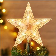 a lighted star on top of a christmas tree