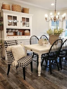 a dining room table and chairs with black and white checkered cushions