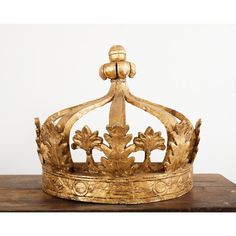 a gold crown sitting on top of a wooden table