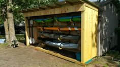 a wooden shed with kayaks in it