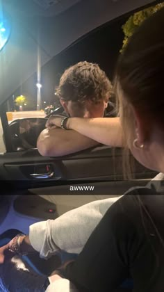 two people sitting in the back seat of a car