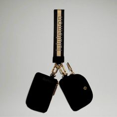 two black tags attached to a gold colored lanyard