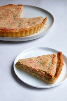 two slices of pie on plates with sprinkles