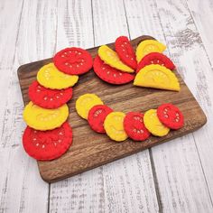 a wooden cutting board topped with sliced up fruit