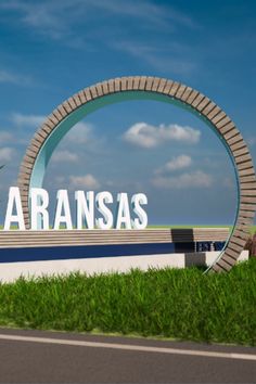 the sign for saransas is in front of some green grass and blue sky