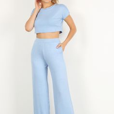 Solid Two Piece Pants Set Featuring A Short Sleeve Crop Top And High Waisted Wide Leg Pants With Pockets. Spring Loungewear Pant Set With Pockets, Casual Pants In A Matching Set, Casual Stretch Sets With High-waisted Pants, Blue Stretch Sets With Pockets, Blue Stretch Cropped Bottoms, Casual Fitted Cropped Wide Leg Pants, Casual High Waist Fitted Pant Set, Casual Spring Matching Set Bottoms, Blue Trousers Sets For Spring