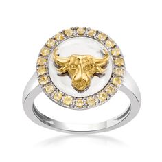 a ring with a bull's head in the center surrounded by yellow and white diamonds