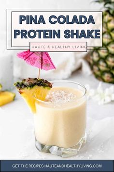 pina colada protein shake in a glass with an umbrella sticking out of it