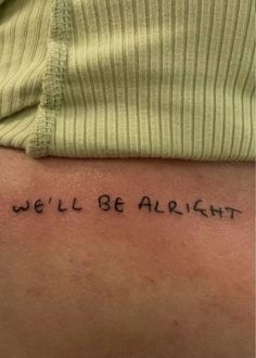 a person with a tattoo that says we'll be alright