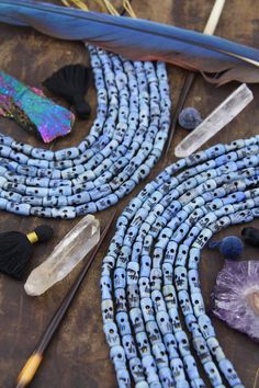 beads and feathers are laid out on a table