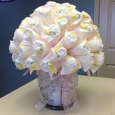 a vase filled with lots of diapers on top of a table