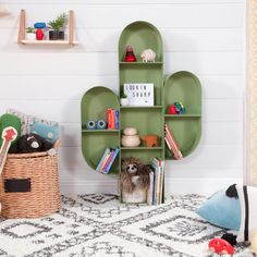 a green shelf with books and stuffed animals on it in a child's room