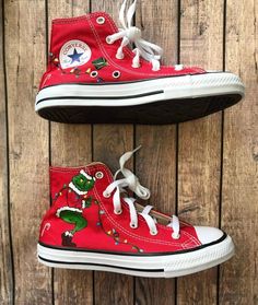 Christmas hand-painted converse. Photos above are converse in red in youth size 2. Please specify color and size when ordering. Perfect for the Christmas lover in your life! Both shoes have the Grinch holding Christmas lights. The lights go around each shoe. There are presents and candy canes scattered around each shoe. Please place your Christmas order by December 1st. Christmas Converse, Painted Converse High Tops, Converse Painted, Hand Painted Toms, Painted Converse, Tie Sneakers, Embroidered Converse, Custom Shoes Diy, High Top Converse