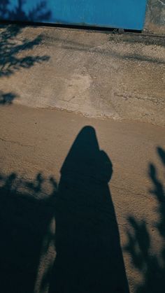 the shadow of a person riding a skateboard